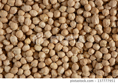 Raw uncooked chickpeas background top view. Raw uncooked chickpeas background top view. 137777951