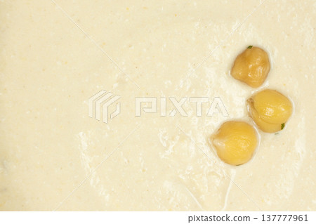 Boiled chickpeas on top of hummus texture macro 137777961