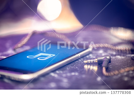 Close up of phone screen with music icon and headphone jack. Close up of phone screen with music icon and headphone jack. 137778308