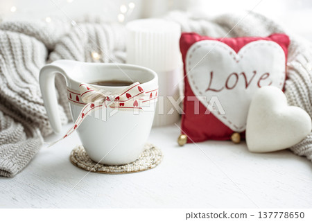 Festive composition with a cup and decor details for Valentine's Day. 137778650
