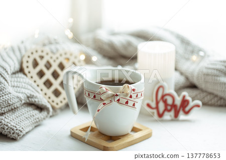 Festive composition with a cup and decor details for Valentine's Day. 137778653