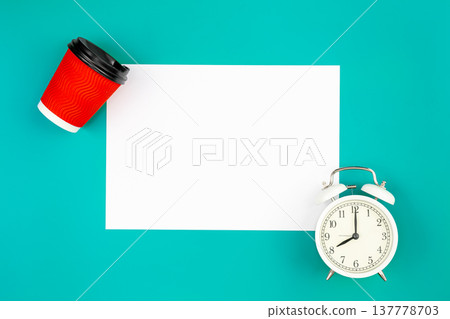 Flat lay, alarm clock and paper cup of coffee on blue background, flat lay. 137778703