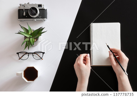 Flat lay composition with hands and blank notepad on black and white background. Flat lay composition with hands and blank notepad on black and white background. 137778735