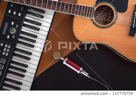 Flat lay, music background with acoustic guitar and piano. Flat lay, music background with acoustic guitar and piano. 137778759