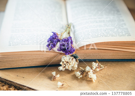 Flower of colorful dried flowers on an open book, close-up. Flower of colorful dried flowers on an open book, close-up. 137778805
