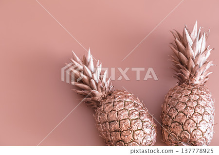 Gold colored pineapple on a colored background. Tropical flat lay. Food concept. Gold colored pineapple on a colored background. Tropical flat lay. Food concept. 137778925