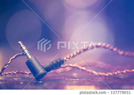 Headphone jack on blurred background with stage lighting. Headphone jack on blurred background with stage lighting. 137779031