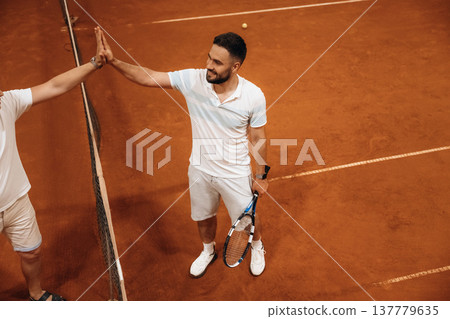 Two male tennis players are together indoors 137779635