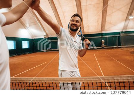 Two male tennis players are together indoors 137779644