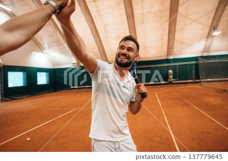 Two male tennis players are together indoors 137779645