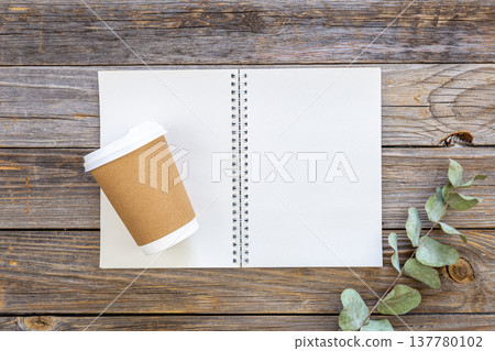 Paper disposable cup and notepad made from recycled paper cups, top view. Paper disposable cup and notepad made from recycled paper cups, top view. 137780102