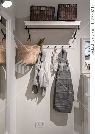 Place for outerwear in the hallway, home interior. Place for outerwear in the hallway, home interior. 137780212
