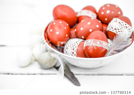 Red Easter eggs on a white plate Red Easter eggs on a white plate 137780314