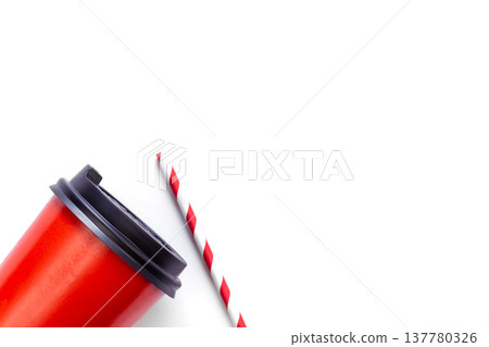 Red paper cup and paper straw for drinks on white background, flat lay. Red paper cup and paper straw for drinks on white background, flat lay. 137780326