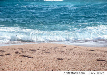 Seascape with turquoise waves with mountains on the horizon. Seascape with turquoise waves with mountains on the horizon. 137780424