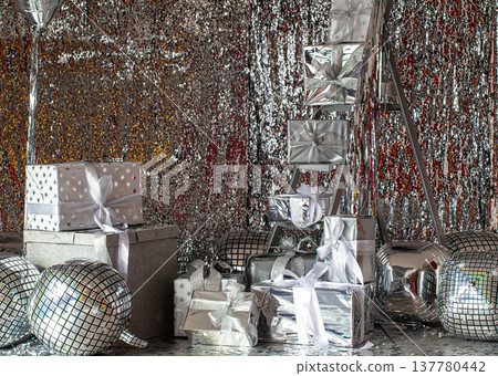 Silver festive Christmas boxes on a shiny background. Silver festive Christmas boxes on a shiny background. 137780442