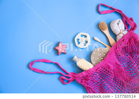 Spa composition with bath accessories in a pink string bag, flat lay. Spa composition with bath accessories in a pink string bag, flat lay. 137780514