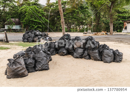 Pile of garbage bags collected on tropical beach after festival cleanup Koh Samui Thailand Pile of garbage bags collected on tropical beach after festival cleanup Koh Samui Thailand 137780954