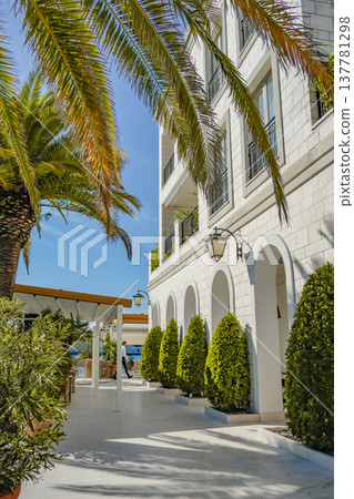 White Building Facade with Arches and Palm Trees in Tivat White Building Facade with Arches and Palm Trees in Tivat 137781298