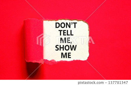 Tell or show symbol. Concept words Do not tell me, show me on beautiful white paper. Beautiful red paper background. Business tell or show concept. Copy space. Tell or show symbol. Concept words Do not tell me, show me on beautiful white paper. Beautiful red paper background. Business tell or show concept. Copy space. 137781347