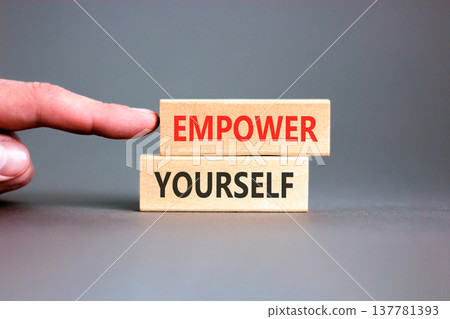 Empower yourself words symbol. Concept words Empower yourself on beautiful wooden blocks. Beautiful grey background. Businessman hand. Business lifestyle Empower yourself words concept. Copy space. 137781393
