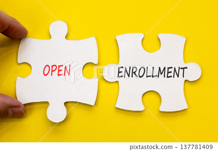 Open enrollment words symbol. Concept words Open enrollment on beautiful white puzzles. Beautiful yellow background. Doctor hand. Medical and Open enrollment words concept. Copy space. 137781409