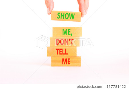 Tell or show symbol. Concept words Show me, do not tell me on beautiful wooden blocks. Beautiful white paper background. Businessman hand. Business tell or show concept. Copy space. 137781422