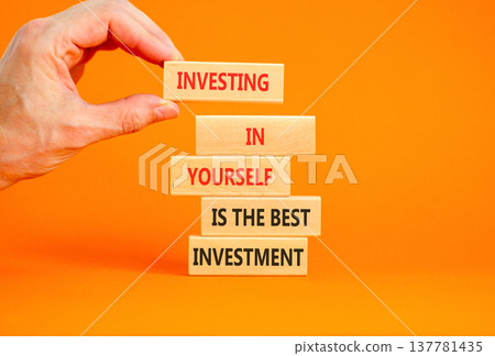 Investing in yourself symbol. Concept words Investing in yourself is the best investment on beautiful wooden blocks. Beautiful orange background. Business investing in yourself concept. Copy space 137781435