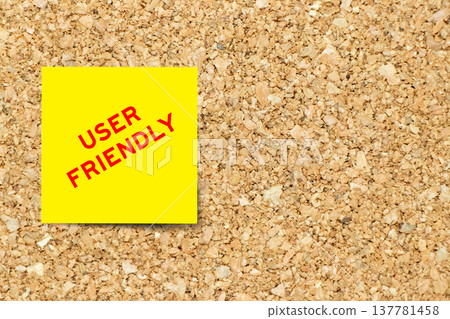 Yellow note paper with word user friendly on cork board background with copy space Yellow note paper with word user friendly on cork board background with copy space 137781458