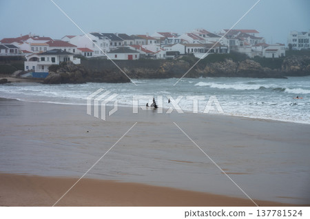 Surfers on Baleal beach, in Portugal, on a very foggy day Surfers on Baleal beach, in Portugal, on a very foggy day 137781524