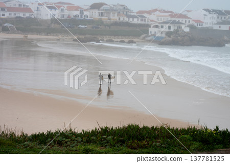 Surfers on Baleal beach, in Portugal, on a very foggy day Surfers on Baleal beach, in Portugal, on a very foggy day 137781525