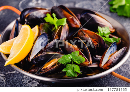 Delicious seafood mussels with sauce and parsley. Delicious seafood mussels with sauce and parsley. 137781565