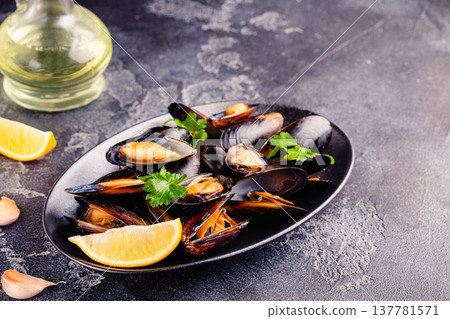 Delicious seafood mussels with sauce and parsley. Delicious seafood mussels with sauce and parsley. 137781571