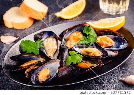 Delicious seafood mussels with sauce and parsley. Delicious seafood mussels with sauce and parsley. 137781572