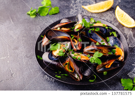 Delicious seafood mussels with sauce and parsley. 137781575