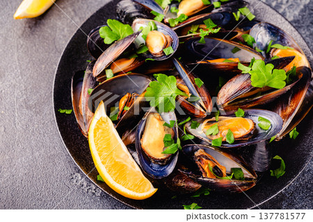 Delicious seafood mussels with sauce and parsley. Delicious seafood mussels with sauce and parsley. 137781577