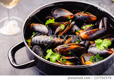 Delicious seafood mussels with sauce and parsley. Delicious seafood mussels with sauce and parsley. 137781579