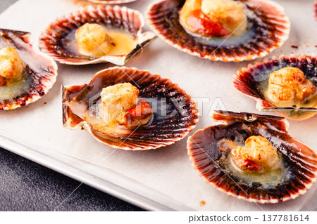 Cooked scallops with melted butter Cooked scallops with melted butter 137781614