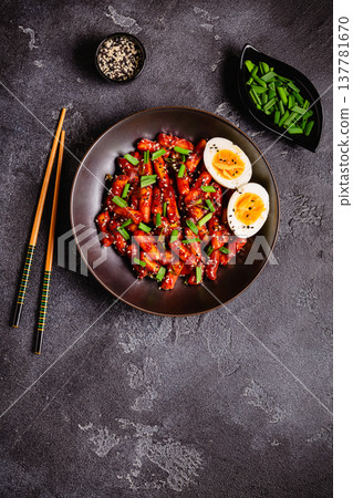 Tteokbokki, Teopokki fried rice cake in black bowl. 137781670