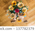 Handheld Rustic Sunflower and Red Rose Bouquet with Long Burlap Ribbon. Elegant Vertical Floral Arrangement for Anniversary, Wedding, or Romantic Gift. Beautiful Bright Yellow and Crimson Flowers. 137782379
