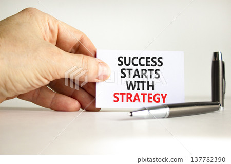 Success starts with strategy symbol. Concept words Success starts with strategy on beautiful white paper. Beautiful white background. Business and success starts with strategy concept. Copy space. 137782390