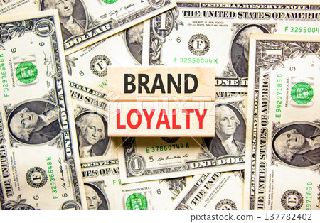 Brand loyalty words symbol. Concept words Brand loyalty on beautiful wooden blocks. Beautiful dollar bills background. Dollar bills. Business and Brand loyalty words concept. Copy space. Brand loyalty words symbol. Concept words Brand loyalty on beautiful wooden blocks. Beautiful dollar bills background. Dollar bills. Business and Brand loyalty words concept. Copy space. 137782402