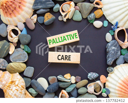 Palliative care words symbol. Concept words Palliative care on beautiful wooden blocks. Beautiful black background. Sea stones sea shells. Medical and Palliative care words concept. Copy space. 137782412