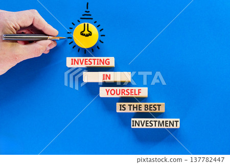 Investing in yourself symbol. Concept words Investing in yourself is the best investment on beautiful wooden blocks. Beautiful blue background. Business investing in yourself concept. Copy space Investing in yourself symbol. Concept words Investing in yourself is the best investment on beautiful wooden blocks. Beautiful blue background. Business investing in yourself concept. Copy space 137782447