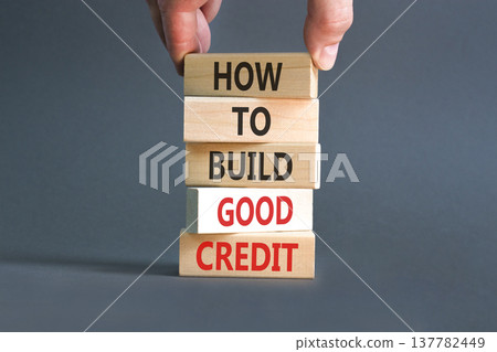 How to build good credit symbol. Concept words How to build good credit on beautiful wooden blocks. Beautiful grey background. Businessman hand. Business how to build good credit concept. Copy space How to build good credit symbol. Concept words How to build good credit on beautiful wooden blocks. Beautiful grey background. Businessman hand. Business how to build good credit concept. Copy space 137782449