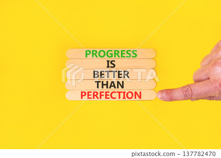 Progress or perfection words symbol. Concept words Progress is better than perfection on beautiful wooden sticks. Beautiful yellow paper background. Business progress or perfection concept. Copy space 137782470