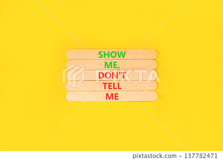 Tell or show symbol. Concept words Show me, do not tell me on beautiful wooden sticks. Beautiful yellow paper background. Business tell or show concept. Copy space. Tell or show symbol. Concept words Show me, do not tell me on beautiful wooden sticks. Beautiful yellow paper background. Business tell or show concept. Copy space. 137782471