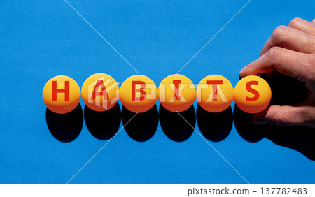 Habits support and help symbol. Concept word Habits on beautiful orange table tennis ping pong balls. Beautiful blue background. Business psychological habits support and help concept. Copy space. Habits support and help symbol. Concept word Habits on beautiful orange table tennis ping pong balls. Beautiful blue background. Business psychological habits support and help concept. Copy space. 137782483