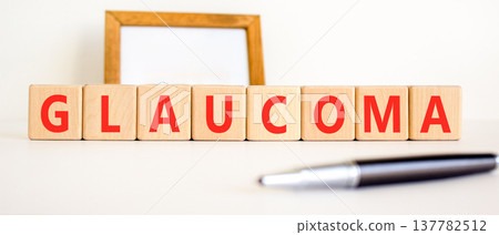 Glaucoma word symbol. Concept word Glaucoma on beautiful wooden blocks. Beautiful white background. Beautiful black pen. Medical support help glaucoma word concept. Copy space. 137782512
