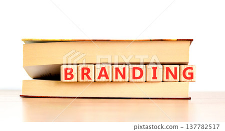 Branding brand word symbol. Concept word Branding on beautiful wooden blocks in beautiful book. Beautiful wooden table white background. Business support help branding brand word concept. Copy space. Branding brand word symbol. Concept word Branding on beautiful wooden blocks in beautiful book. Beautiful wooden table white background. Business support help branding brand word concept. Copy space. 137782517